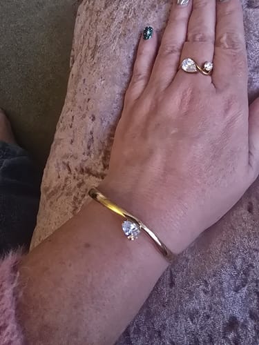 Customer wearing the gold-tone Pia Bangle and matching ring mentioned in their review.