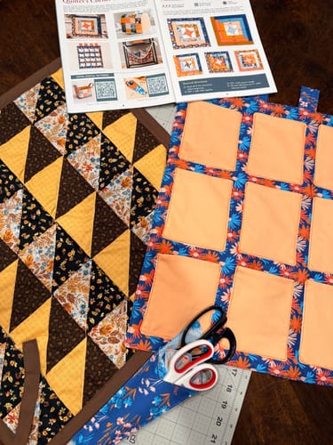 Customer's finished projects from Mrs Quilty Subscription Box 6, including a hanging organizer and a quilt top.