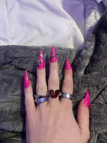 Reviewer's hand wearing the Promise Ring, featuring a detailed, red heart-shaped stone.