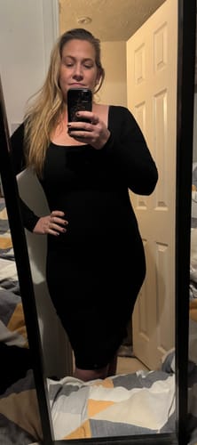 Reviewer in a mirror selfie, showing the smooth silhouette of the black Long Sleeve Midi Shapewear Dress.