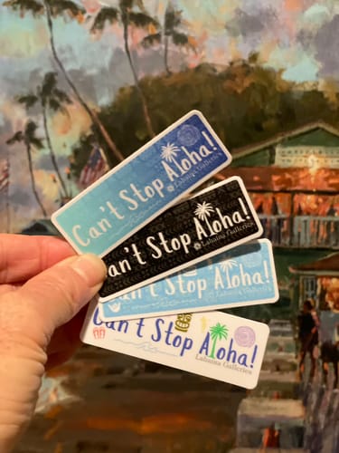 Customer's hand holding four custom vinyl stickers with different 'Can't Stop Aloha!' designs.