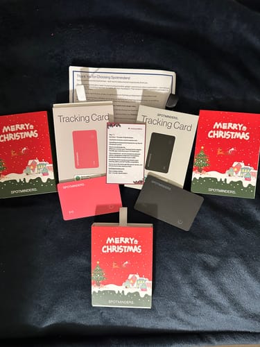 Reviewer's pink and black SPOTMINDERS Tracking Cards displayed with festive Christmas edition packaging.