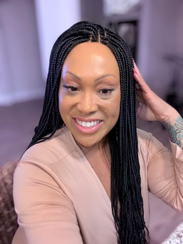 Customer smiling while wearing the black Box Braid Wig, showing the neat 4 by 4 lace closure.