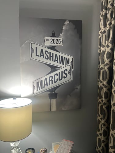 Customer's black-and-white personalized canvas showing street signs with the names 'Lashawn', 'Marcus', and 'EST. 2025'.