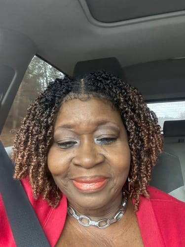A customer smiling while wearing the Chade Magic Lace Braid Wig. The short, two-tone Yanky Twist style looks natural.