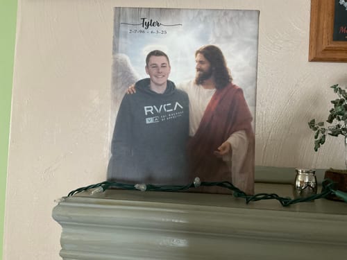 Reviewer's personalized memorial canvas of a young man with Jesus, displayed on a mantel.