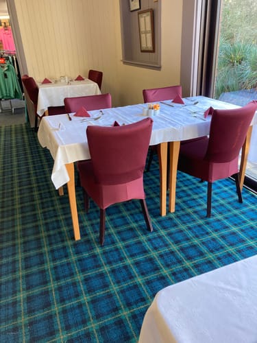 Customer's dining chairs with covers made from the wine-colored sweatshirt fabric in a club restaurant.