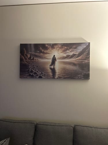 Customer's 'Walking on Water' faith wall art, the 24x48 size, hanging on a wall above a gray couch.