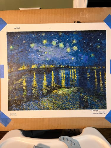 Customer's finished Starry Night Over the Rhône paint-by-numbers project, taped to a board.