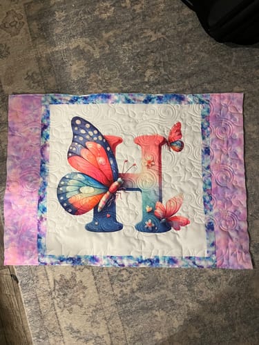 Customer's completed pillow sham using the colorful Watercolor Butterfly Letter 'H' Fabric Panel.