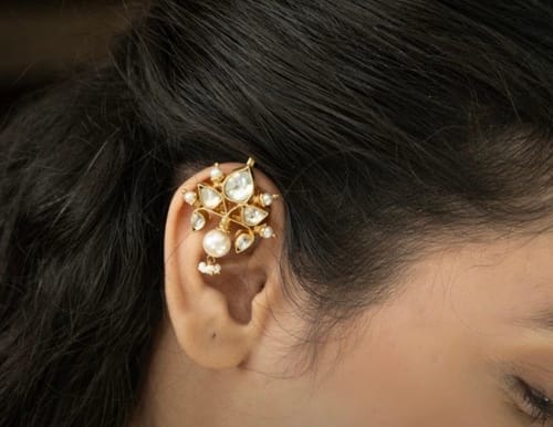 Customer wearing the gold-plated kamal Earcuff with kundan stones and pearls on their ear.