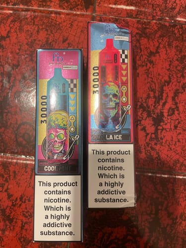 Reviewer shows the colorful packaging for two RandM Tornado vape bars, displaying the Cool Mint and LA Ice flavors.