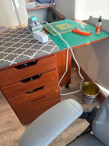 Customer's Kangaroo Kiwi Multi-Use Cabinet in Teak, set up for ironing and cutting in a craft room.