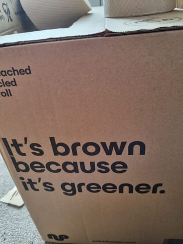 Customer's cardboard box for Unbleached Recycled Toilet Paper with the slogan 'It's brown because it's greener'.
