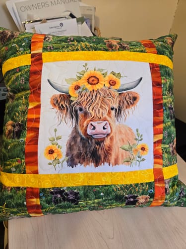 Customer's quilted pillow using the Sunflowers & Highland Cows fabric panel as the colorful center.