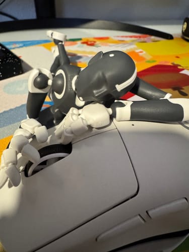Reviewer's Dark Frost Stickybones figure in a relaxed pose, reclining on a computer mouse with one hand on the scroll wheel.