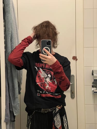 Partial view of a reviewer in a mirror selfie wearing the baggy Denim Barrel Jeans.