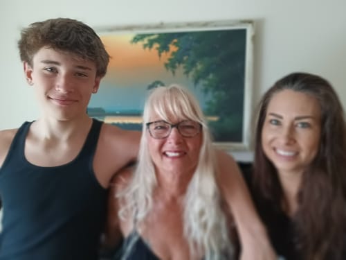 A reviewer's photo of three smiling people for their Good Night Formula review.