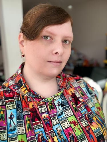 Reviewer wearing the colorful Marvel "Corner Box Brigade" Performance Hoodie showing the repeating comic pattern.