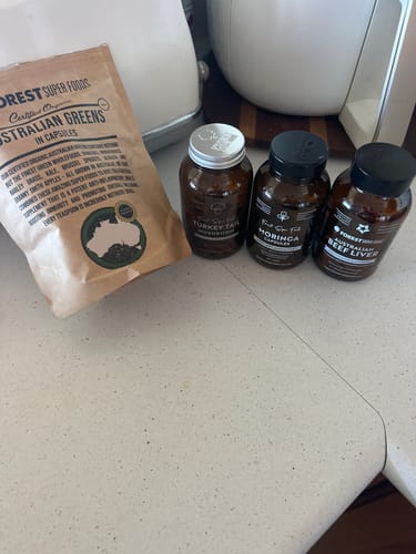 Customer's Australian Organic Beef Liver Capsules bottle on a counter with other supplement products.