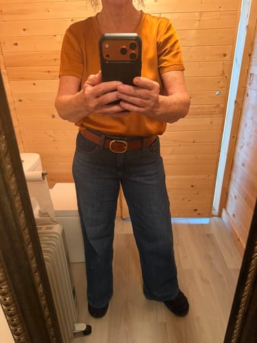 Reviewer in a mirror selfie showing the fit of the wide-leg Silver Suki Mid Rise Knit Flex Jeans.