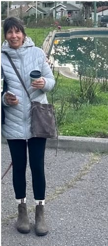 Customer standing outdoors wearing the black Stella Petite leggings with a light puffer jacket and boots.