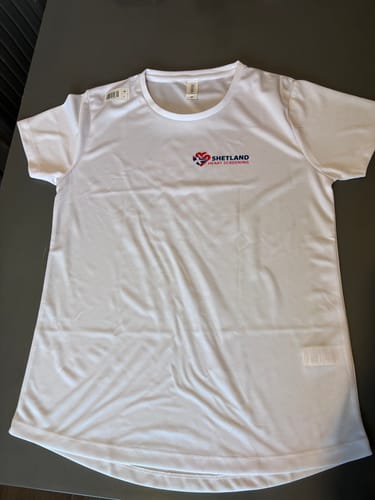 Customer's white technical t-shirt with a small 'Shetland Heart Screening' logo printed on the chest.