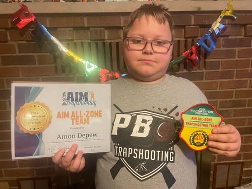 Reviewer's photo of a young person with trapshooting awards, who uses the GS Extreme 3.0 for the sport.