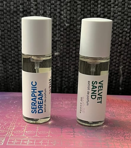 Customer's small Seraphic Dream perfume bottle shown next to another fragrance on a decorative surface.