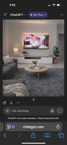 Customer's large, dark grey Mellow Mat placed under a coffee table in a modern living room.