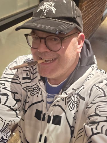 Reviewer shows the blue Flynn Circuit Tron Knitted Sweater worn under a white, circuit-patterned hoodie.