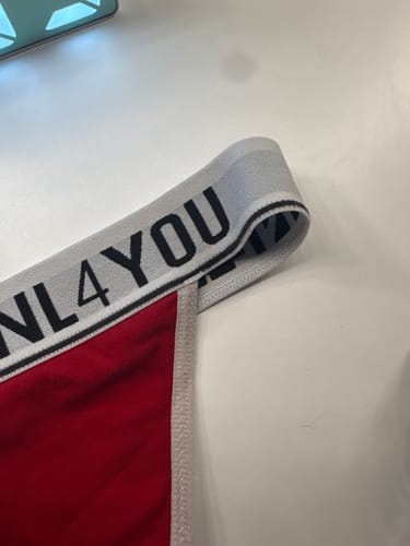 Customer's close-up of the red Christmas underwear, showing the white elastic waistband with NL4YOU branding.