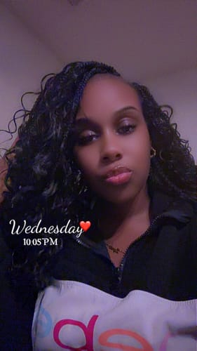 Close-up of a reviewer wearing the black, curly Mayde Wet & Curly Boho Braids.