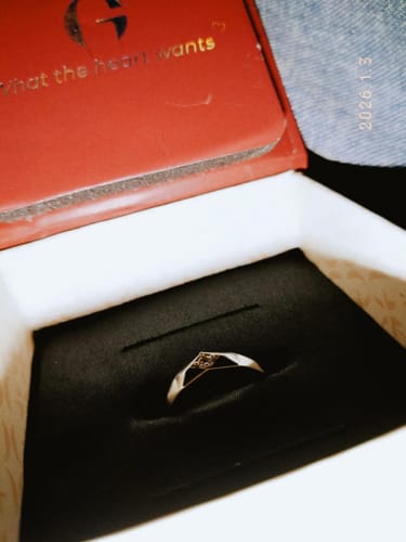 Customer's Silver Rugged Ring sitting inside its open, black-lined jewelry box with a red lid.