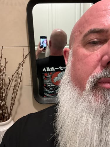 Customer showing the back graphic of the black RISING TIDES TEE in a mirror selfie.