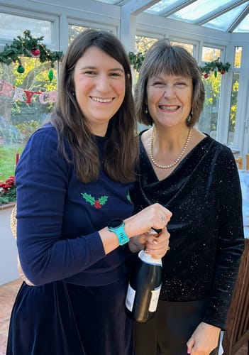Reviewer wearing a black cowl-neck top made from the Sparkly Plain Velvet Fabric at a festive gathering.