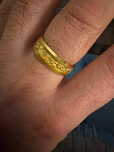 Close-up of a customer wearing the Aureum ring, showing its textured gold foil inlay.