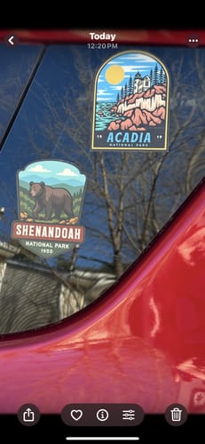 Reviewer's Acadia National Park sticker applied to a car window next to another park sticker.