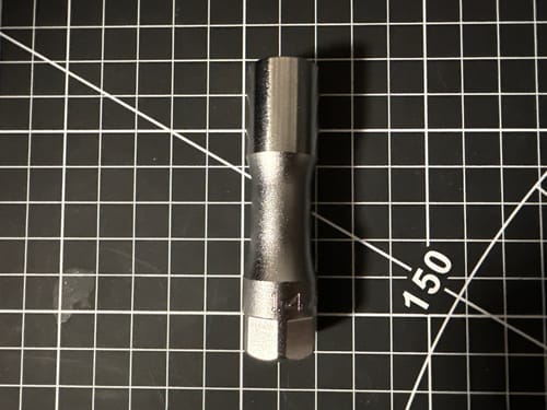 Customer's Ko-ken 14 mm hex socket resting on a black gridded cutting mat.