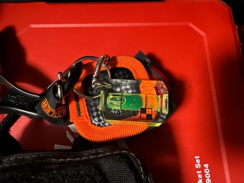 Reviewer's Stabila Mini Level Key Chain attached to the strap of an EDC tool kit pouch.