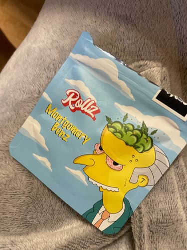 Customer's packaging for Montgomery Benz THCA Flower, a blue pouch with a prominent cartoon design.