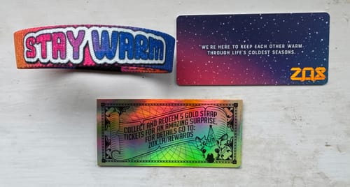 Customer's Stay Warm Bracelet showing the colorful 'STAY WARM' text on the outside, with its collectible cards.