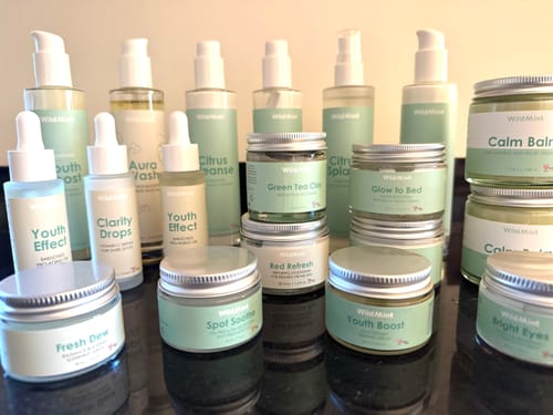 Reviewer's Glow to Bed cream in a jar, displayed with other matching skincare products.