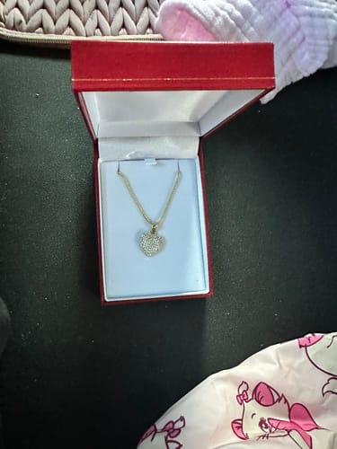 Customer's 14 K Heart CZ Pendant and chain in an open red jewelry box.