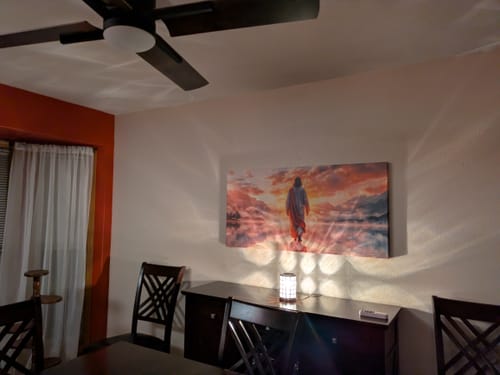 Customer's beautiful Reflections Faith Wall Art II with a red sunset, displayed above a sideboard in a dining room.