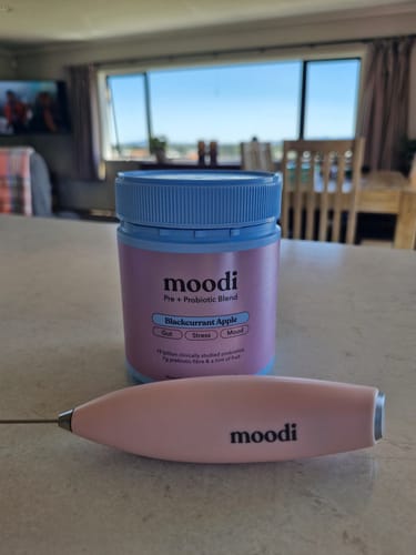 Customer's moodi Blackcurrant Apple blend and branded pink frother on a kitchen counter.