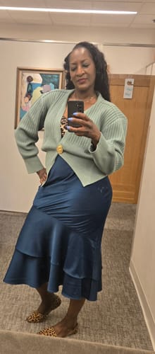 Customer in a fitting room wearing the light green Lapel Knitted Cardigan with the collar visible.