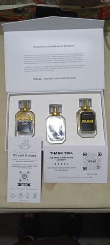 Customer's OUD Supreme BUNDLE in its open presentation box with three elegant perfume bottles inside.