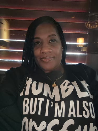 Reviewer wearing the black 'Humble But Also Pressure' sweatshirt.
