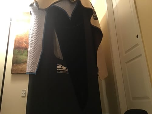 Reviewer's black Sauna Pod 2.0 with a quilted blanket draped over it for extra insulation indoors.